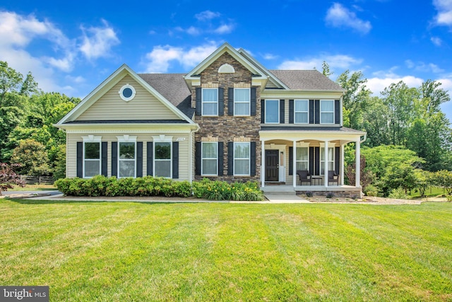 2058 Baythorne Rd, Prince Frederick, MD 20678 - view of front of home with stone siding, a porch, a front yard, and a shingled roof