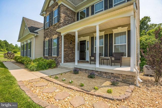 2058 Baythorne Rd, Prince Frederick, MD 20678 - view of exterior entry with a porch, stone siding, and roof with shingles