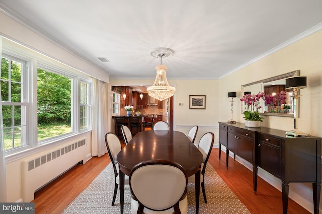 653 Broad Acres Rd, Penn Valley, PA 19072 - dining area featuring radiator, a chandelier, wood finished floors, and ornamental molding