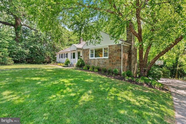 653 Broad Acres Rd, Penn Valley, PA 19072 - view of front facade with a chimney, a front lawn, and stone siding