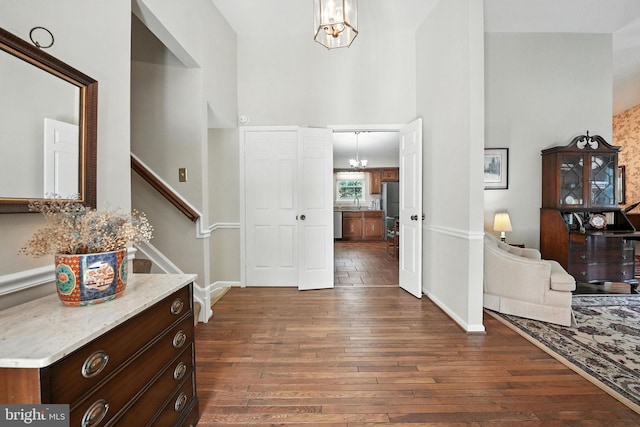 3382 Flint Hill Pl, Woodbridge, VA 22192 - entrance foyer with dark wood finished floors, a chandelier, a towering ceiling, and stairs