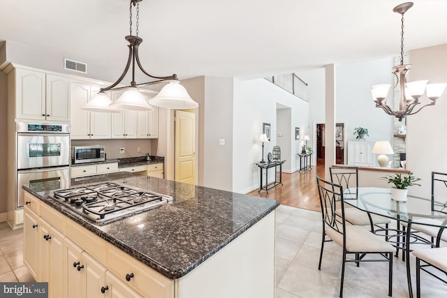 9111 Oak Chase Ct, Fairfax Station, VA 22039 - kitchen with appliances with stainless steel finishes, dark stone countertops, a kitchen island, and pendant lighting