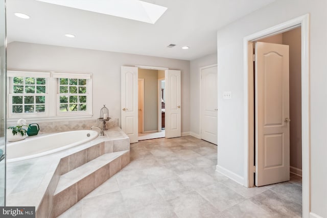 9111 Oak Chase Ct, Fairfax Station, VA 22039 - bathroom featuring a skylight, a bath, and recessed lighting