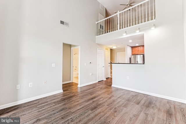 3851 Aristotle Ct Unit 1-412, Fairfax, VA 22030 - unfurnished living room featuring a high ceiling, a ceiling fan, and wood finished floors