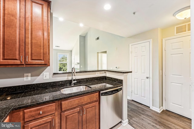 3851 Aristotle Ct Unit 1-412, Fairfax, VA 22030 - kitchen featuring dishwasher, wood finished floors, dark stone countertops, lofted ceiling, and brown cabinets