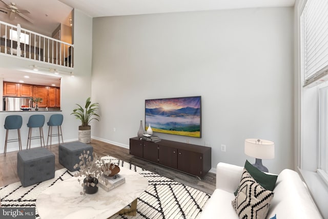 3851 Aristotle Ct Unit 1-412, Fairfax, VA 22030 - living area with wood finished floors, a towering ceiling, and ceiling fan