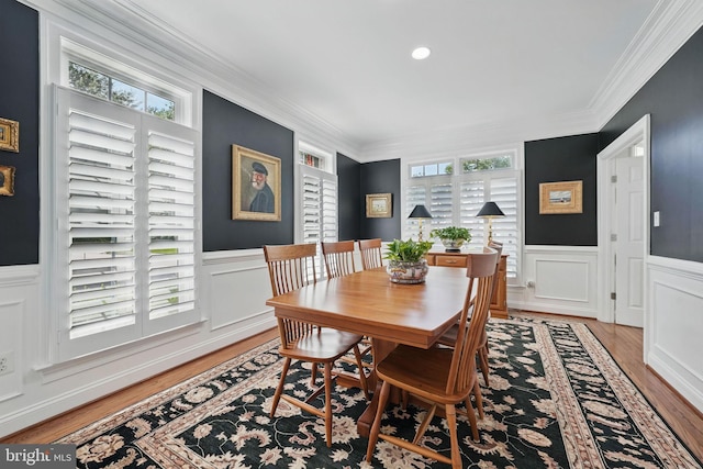 6321 Wilmington Dr, Burke, VA 22015 - dining area featuring light wood-style floors, crown molding, healthy amount of natural light, a wainscoted wall, and a decorative wall