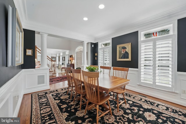 6321 Wilmington Dr, Burke, VA 22015 - dining space with ornate columns, a decorative wall, ornamental molding, wainscoting, and stairs