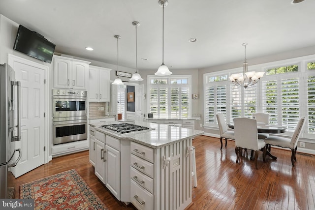 6321 Wilmington Dr, Burke, VA 22015 - kitchen with appliances with stainless steel finishes, a center island, a chandelier, white cabinetry, and dark wood-style floors