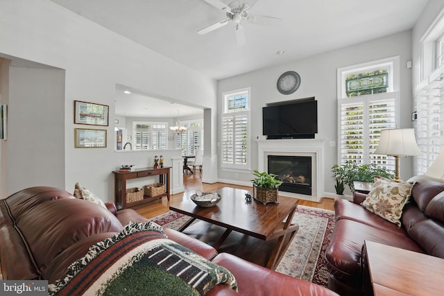 6321 Wilmington Dr, Burke, VA 22015 - living room with a chandelier, a ceiling fan, plenty of natural light, and wood finished floors