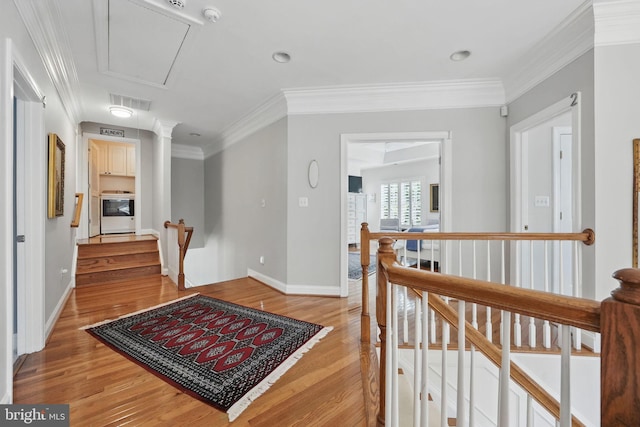 6321 Wilmington Dr, Burke, VA 22015 - corridor featuring attic access, light wood-type flooring, an upstairs landing, and ornamental molding