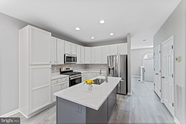 45571 Reading Ter, Sterling, VA 20166 - kitchen with stainless steel appliances, light wood-style floors, white cabinetry, and recessed lighting