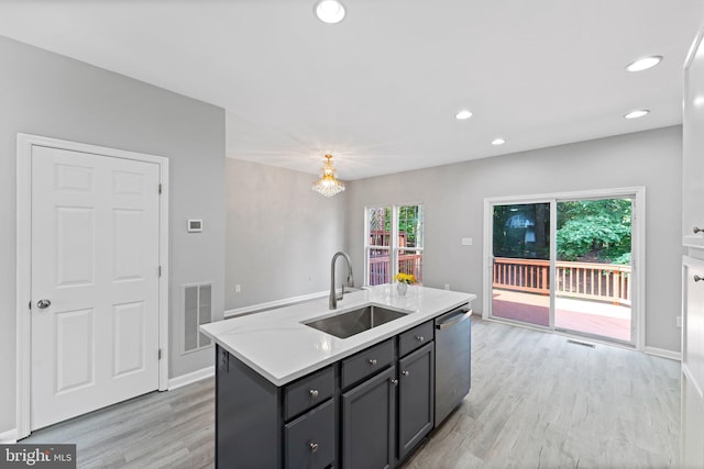 45571 Reading Ter, Sterling, VA 20166 - kitchen featuring dishwasher, a sink, light wood finished floors, light countertops, and an island with sink