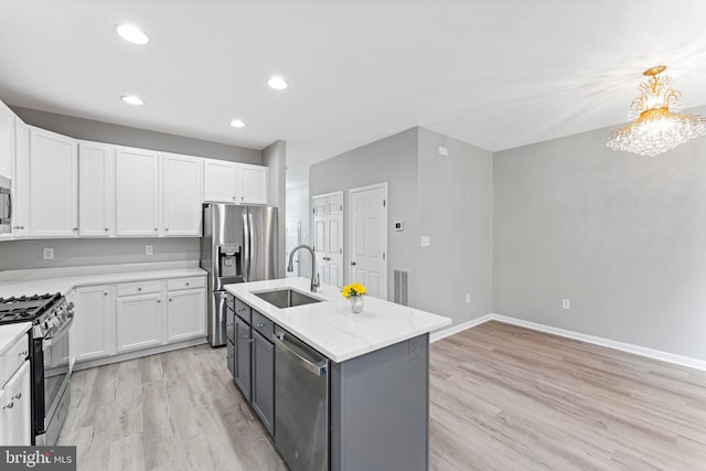 45571 Reading Ter, Sterling, VA 20166 - kitchen featuring appliances with stainless steel finishes, a sink, white cabinets, light wood-type flooring, and recessed lighting