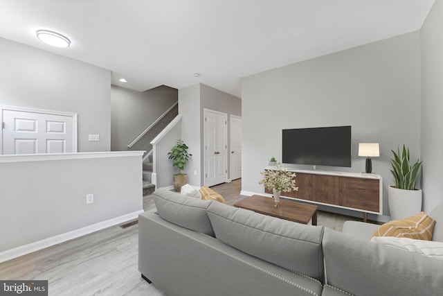 45571 Reading Ter, Sterling, VA 20166 - living room with light wood-style flooring, baseboards, stairway, and recessed lighting
