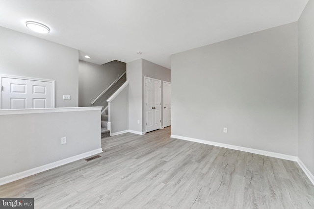 45571 Reading Ter, Sterling, VA 20166 - unfurnished living room with wood finished floors, baseboards, stairs, and recessed lighting