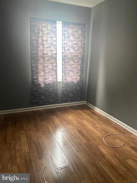 2919 Baker St, Baltimore, MD 21216 - unfurnished room featuring wood finished floors and baseboards