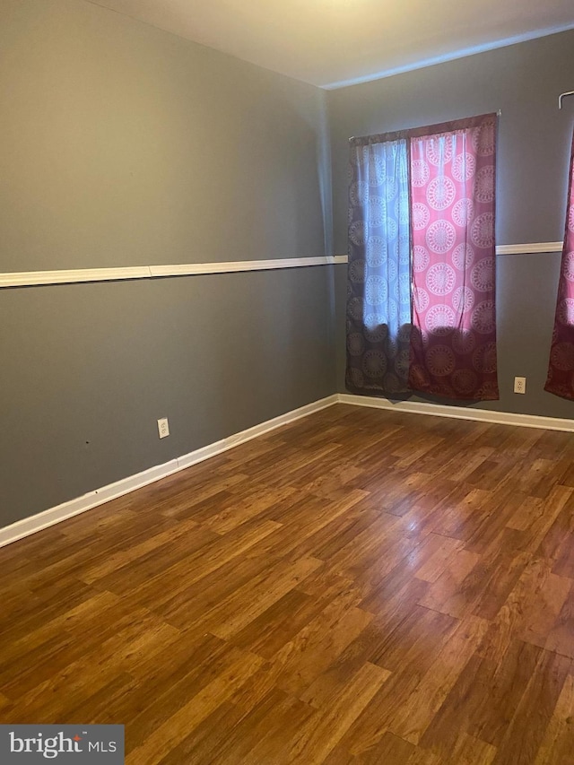 2919 Baker St, Baltimore, MD 21216 - unfurnished room with dark wood-type flooring and baseboards