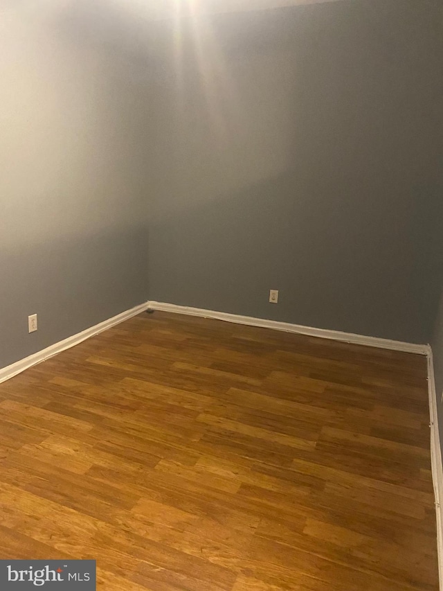 2919 Baker St, Baltimore, MD 21216 - spare room featuring baseboards and wood finished floors