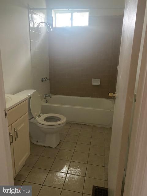 2919 Baker St, Baltimore, MD 21216 - bathroom with tile patterned floors, vanity, toilet, and bathtub / shower combination