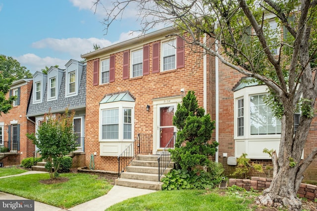 3134 Borge St, Oakton, VA 22124 - view of front of property with brick siding and a front yard