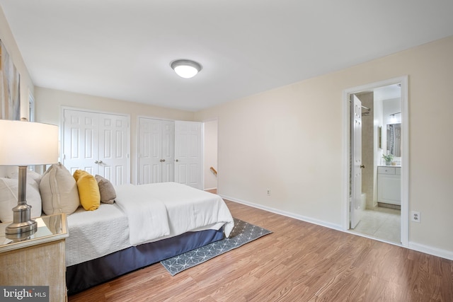 3134 Borge St, Oakton, VA 22124 - bedroom with two closets, wood finished floors, and connected bathroom