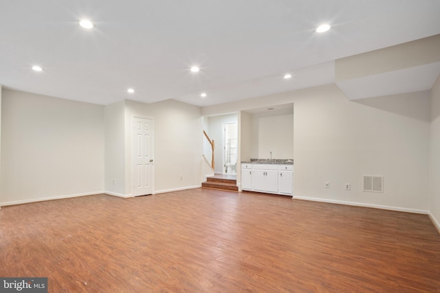 3134 Borge St, Oakton, VA 22124 - below grade area with wood finished floors, stairway, and recessed lighting
