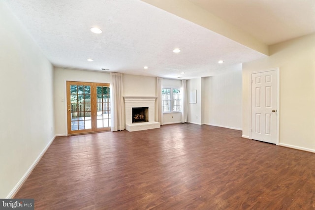 3134 Borge St, Oakton, VA 22124 - unfurnished living room featuring dark wood-style floors, a fireplace with raised hearth, and recessed lighting