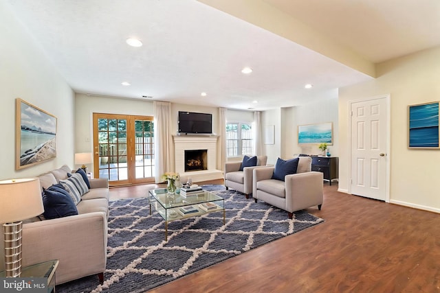 3134 Borge St, Oakton, VA 22124 - living area featuring wood finished floors, a fireplace with raised hearth, and recessed lighting