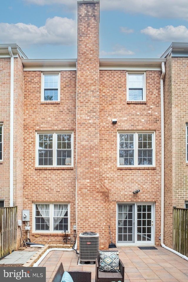 3134 Borge St, Oakton, VA 22124 - rear view of property with brick siding, a chimney, and a patio