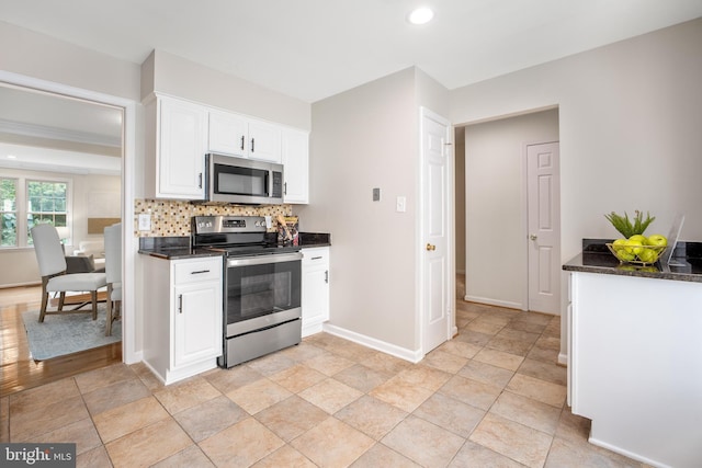3134 Borge St, Oakton, VA 22124 - kitchen with stainless steel appliances, white cabinetry, tasteful backsplash, recessed lighting, and dark stone countertops
