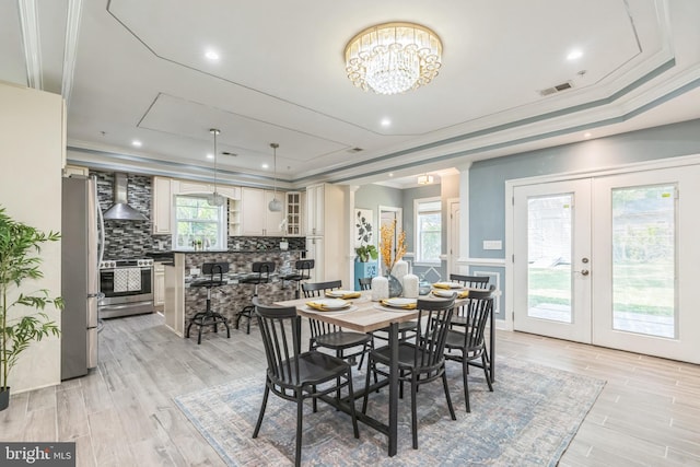 3112 Lancer Dr, Hyattsville, MD 20782 - dining room featuring a tray ceiling, light wood-style floors, french doors, a chandelier, and ornamental molding