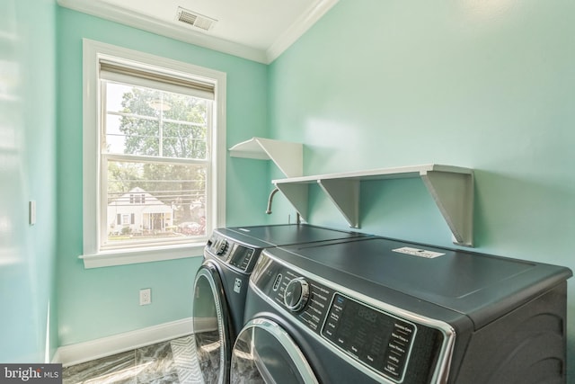 3112 Lancer Dr, Hyattsville, MD 20782 - washroom with washer and clothes dryer, crown molding, and marble look tiles