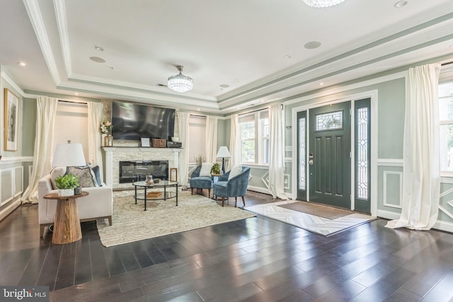 3112 Lancer Dr, Hyattsville, MD 20782 - living area featuring a tray ceiling, a decorative wall, healthy amount of natural light, crown molding, and wood finished floors