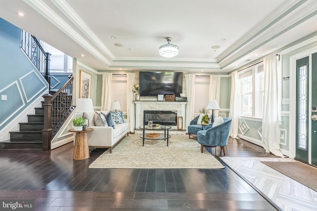 3112 Lancer Dr, Hyattsville, MD 20782 - living room with stairs, a raised ceiling, ornamental molding, a stone fireplace, and wood finished floors