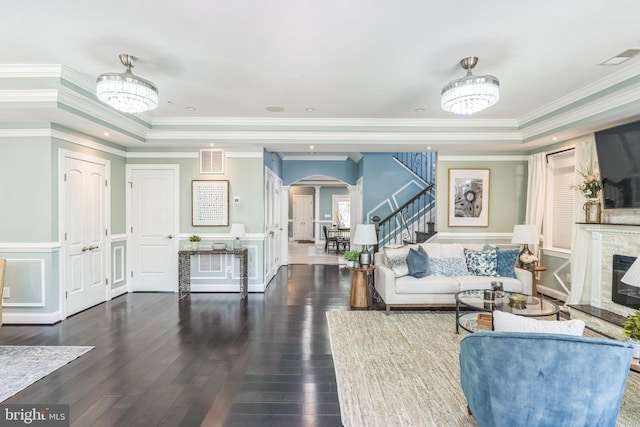 3112 Lancer Dr, Hyattsville, MD 20782 - living room featuring arched walkways, a chandelier, stairway, hardwood / wood-style flooring, and a tray ceiling