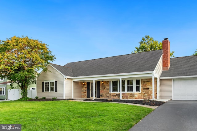 12807 Buckingham Dr, Bowie, MD 20715 - view of front of house with a garage, stone siding, a chimney, driveway, and roof with shingles