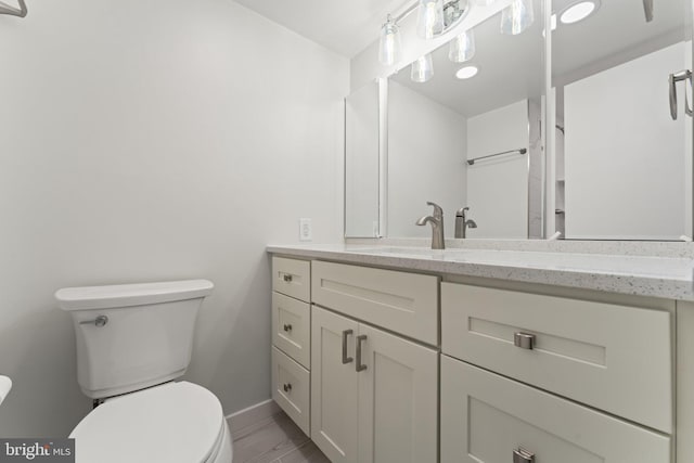 203 Yoakum Pkwy Unit 603, Alexandria, VA 22304 - bathroom featuring toilet, vanity, baseboards, and wood finished floors