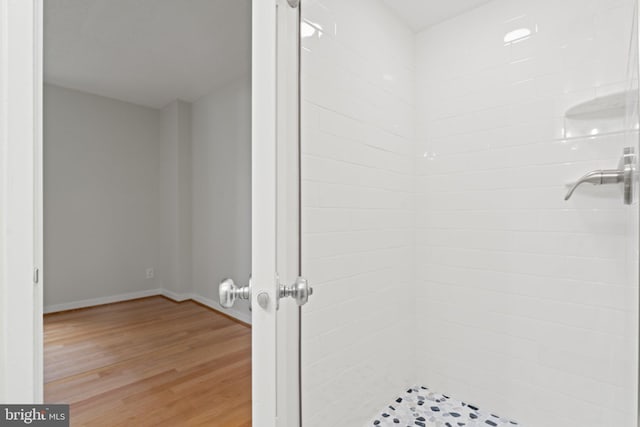 203 Yoakum Pkwy Unit 603, Alexandria, VA 22304 - bathroom with a stall shower, wood finished floors, and baseboards