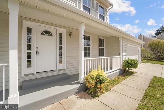 13017 Broadmore, Silver Spring, MD 20904 - view of exterior entry featuring covered porch, an attached garage, and driveway