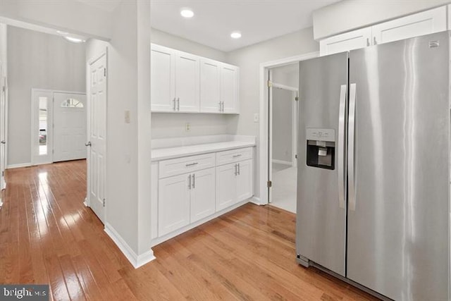 13017 Broadmore, Silver Spring, MD 20904 - kitchen with stainless steel fridge with ice dispenser, light wood-style flooring, white cabinetry, light countertops, and baseboards