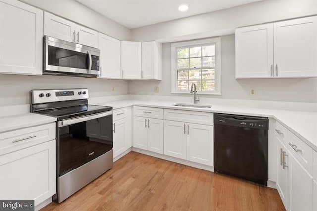 13017 Broadmore, Silver Spring, MD 20904 - kitchen featuring stainless steel appliances, a sink, white cabinets, light countertops, and recessed lighting