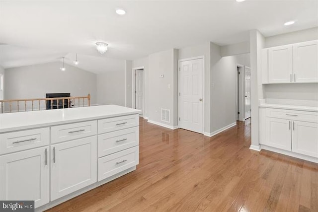 13017 Broadmore, Silver Spring, MD 20904 - kitchen featuring white cabinetry, baseboards, light countertops, recessed lighting, and lofted ceiling