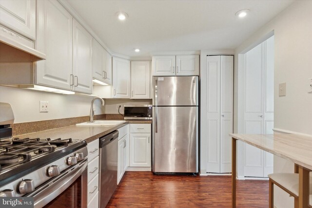 212 Old Forge Xing, Devon, PA 19333 - kitchen featuring appliances with stainless steel finishes, dark wood-type flooring, white cabinets, recessed lighting, and under cabinet range hood