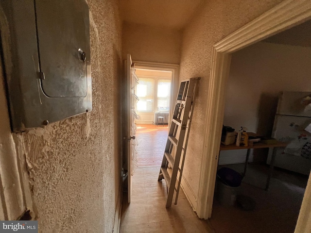 5427 Baltimore Ave, Philadelphia, PA 19143 - corridor with radiator heating unit, electric panel, and a textured wall