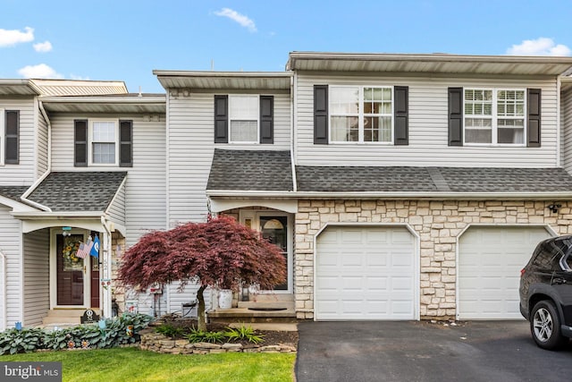 48 Deer Run Rd, Perkasie, PA 18944 - townhome / multi-family property featuring driveway, stone siding, an attached garage, and roof with shingles