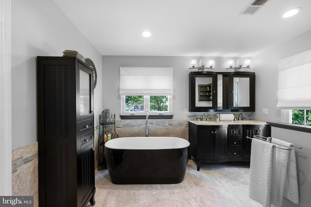18722 Timoney Ct, Leesburg, VA 20176 - bathroom featuring a freestanding tub, double vanity, and recessed lighting