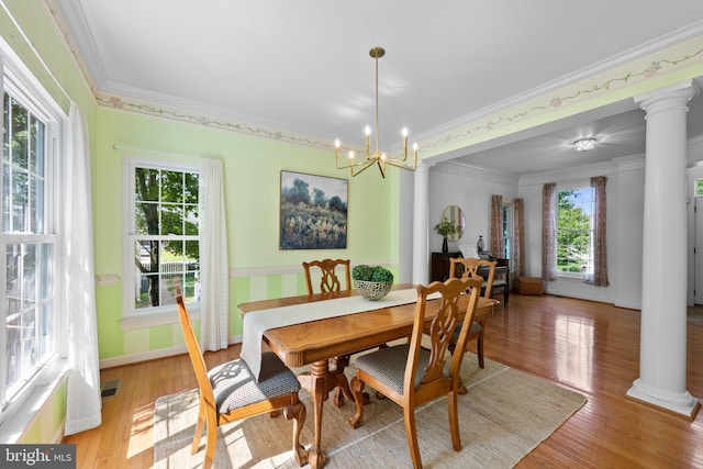 18722 Timoney Ct, Leesburg, VA 20176 - dining room with healthy amount of natural light, crown molding, ornate columns, light wood-type flooring, and a chandelier