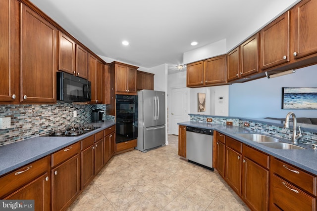 18722 Timoney Ct, Leesburg, VA 20176 - kitchen with black appliances, a sink, decorative backsplash, dark countertops, and recessed lighting