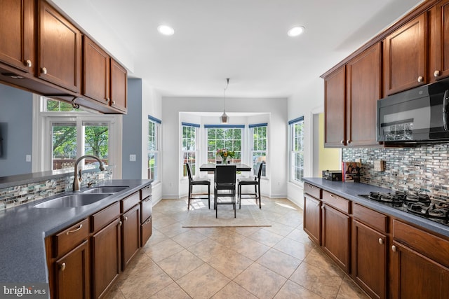 18722 Timoney Ct, Leesburg, VA 20176 - kitchen with a sink, black appliances, dark countertops, tasteful backsplash, and baseboards